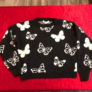 Black sweater with white butterfly details